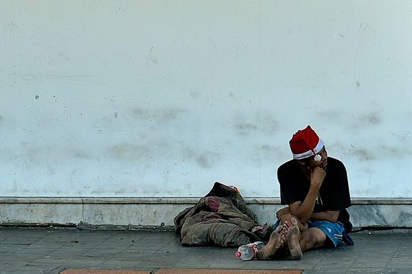 Morador de rua com gorro do Papai Noel, sentado na calçada da Avenida Princesa Isabel, em Vitória . Crédito: Fernando Madeira