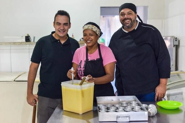 Vitor, à esquerda, coloca a mão na massa e supervisiona a produção dos quindins  por Arquivo pessoal