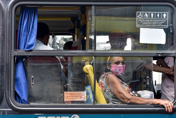 Passageira usa máscara em coletivo que passa pela avenida Jerônimo Monteiro, Centro. por Vitor Jubini