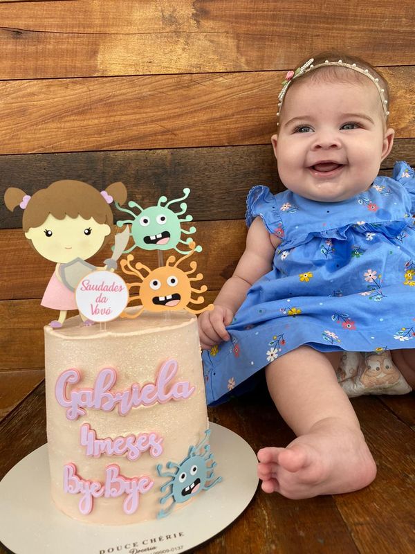 Aos quatro meses, a pequena Gabriela ao lado do bolo que diz "bye bye" para o coronavírus por Acervo pessoal