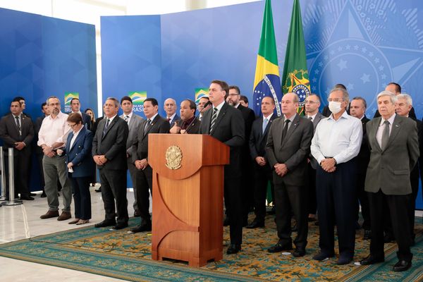 Presidente Jair Bolsonaro em discurso cercado por ministros