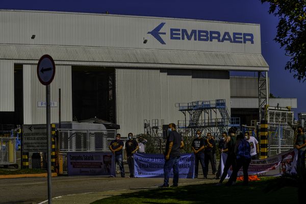 Sindicalistas e funcionários demitidos e não demitidos da Embraer participam de uma assembleia na porta da empresa, em São José dos Campos, interior de São Paulo