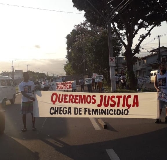 Pessoas na Rodovia Darly Santos, em Vila Velha, carregam faixas em protesto pela morte de Vívian Lima