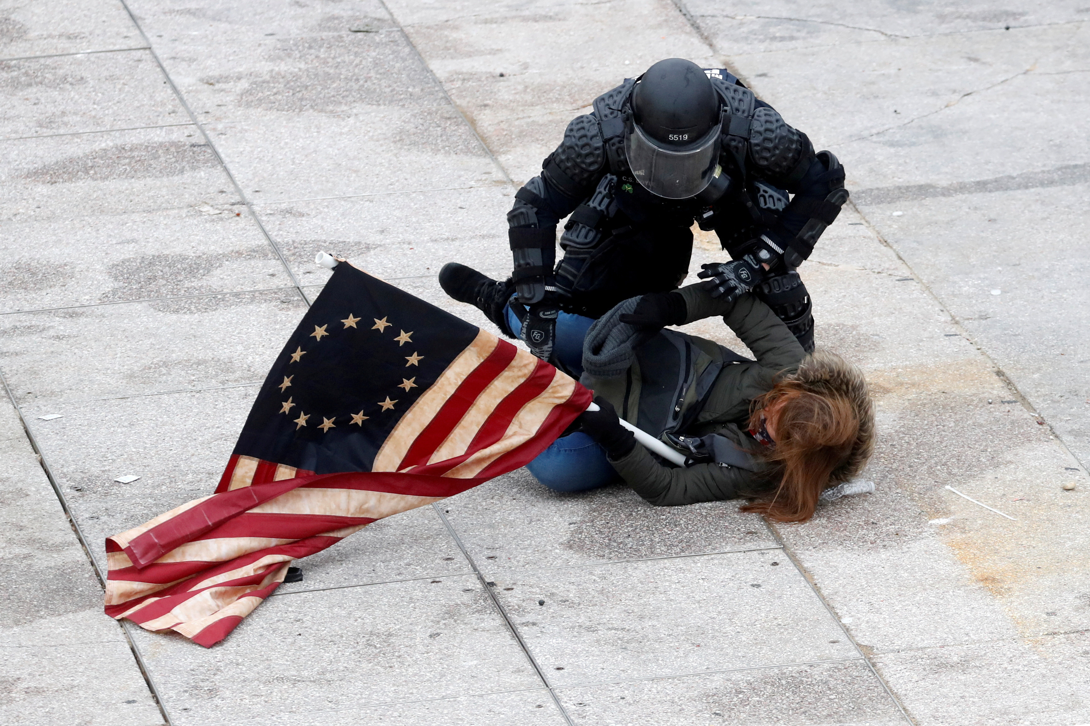 Um policial detém um manifestante pró-Trump dirante a invasão ao Capitólio dos EUA