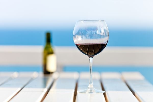 Taça de vinho tinto de verão na praia