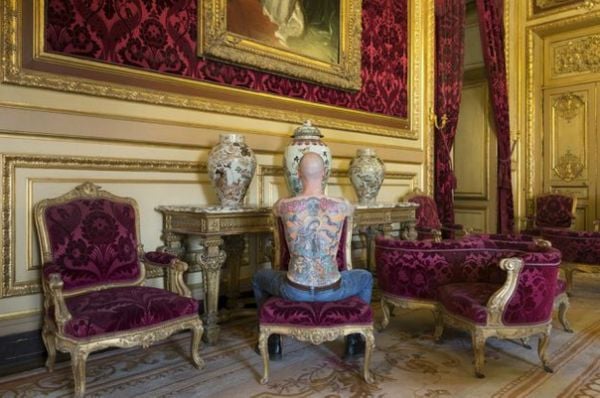 Tim Steiner, cujo desenho nas costas é uma obra de arte, em exposição no Museu do Louvre, em Paris