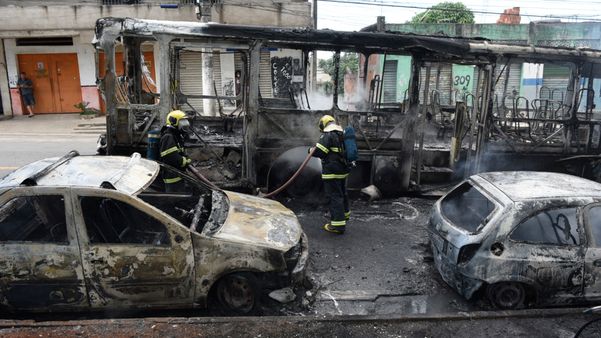 Um ônibus e dois carros ficaram destruídos após grupo de encapuzados atear fogo no coletivo