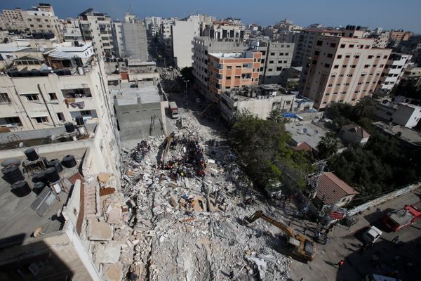 Rescuers search for people in the rubble of a building at the site of Israeli air strikes, in Gaza City May 16, 2021. REUTERS/Mohammed Salem SEARCH 