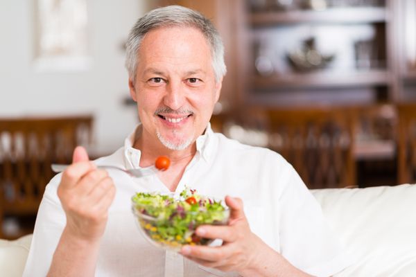 Homem comendo salada