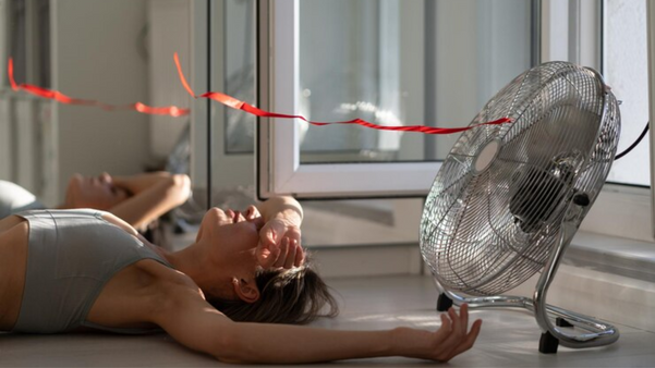 Mulher se refrescando debaixo de ventilador