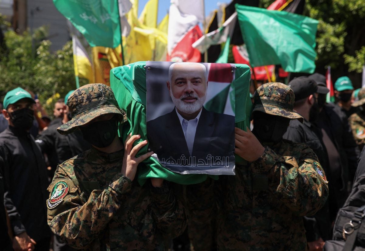 Manifestantes seguram um caixão simulado com uma foto do chefe do Hamas, Ismail Haniyeh, que foi morto no Irã, durante um protesto contra seu assassinato, em Beirute, Líbano, em 2 de agosto de 2024.