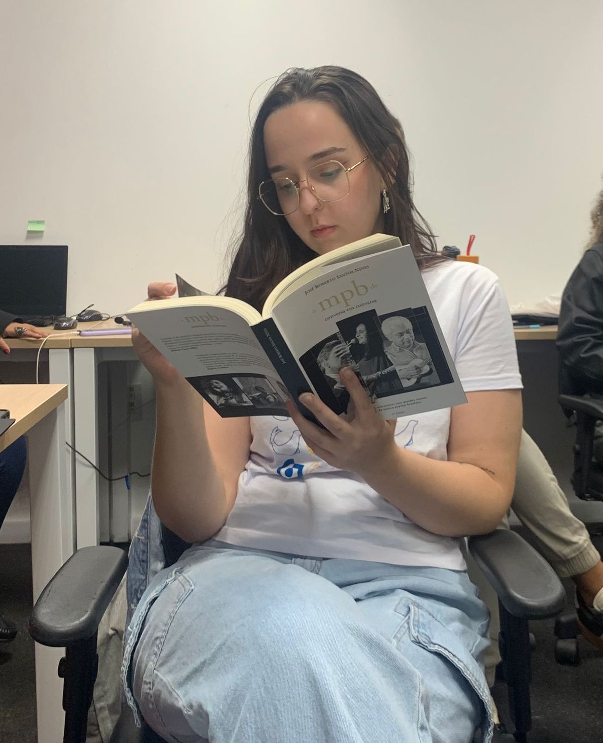 Aluna de residência lendo livro de José Roberto Santos Neves