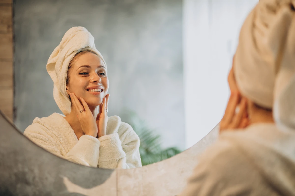Woman at home applying cream mask