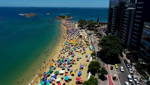 Banhistas aproveitam o domingo de altas temperaturas, e imagens mostram praias cheias e tomadas pelas barracas coloridas nas duas cidades