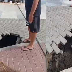 Enquanto mostrava o buraco, um homem quase foi engolido pela queda de outras partes do calçamento; prefeitura informou que o local ainda passa por obras